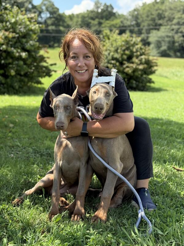 Pet owner with their dogs enjoying reunion after transport