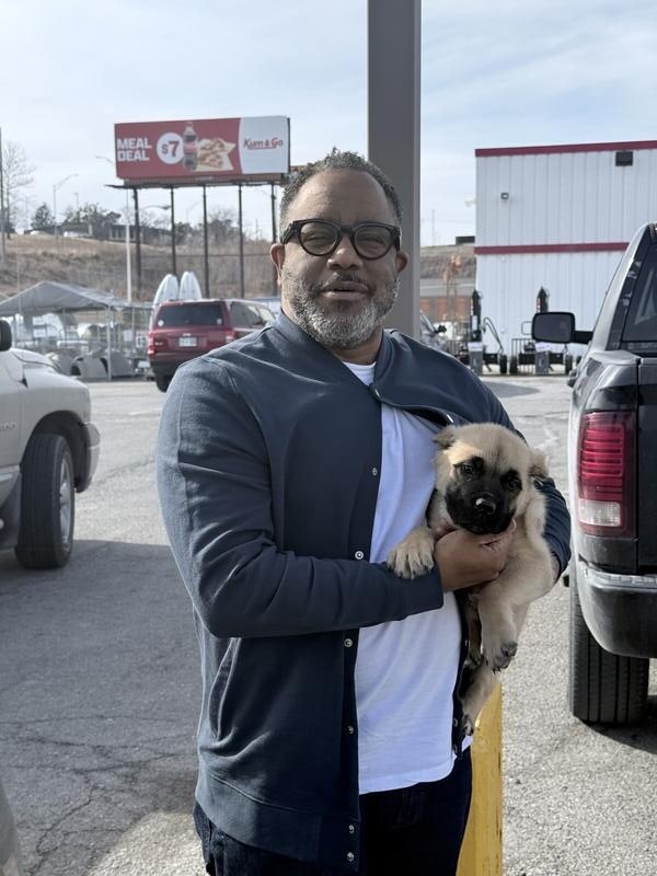 Happy pet owner receiving their puppy from Elite Pet Transportation