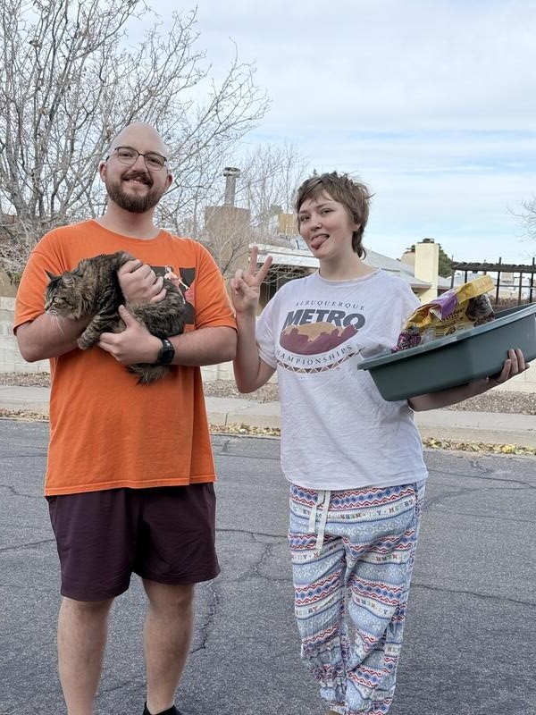 Delighted customers with their cat after pet transport delivery