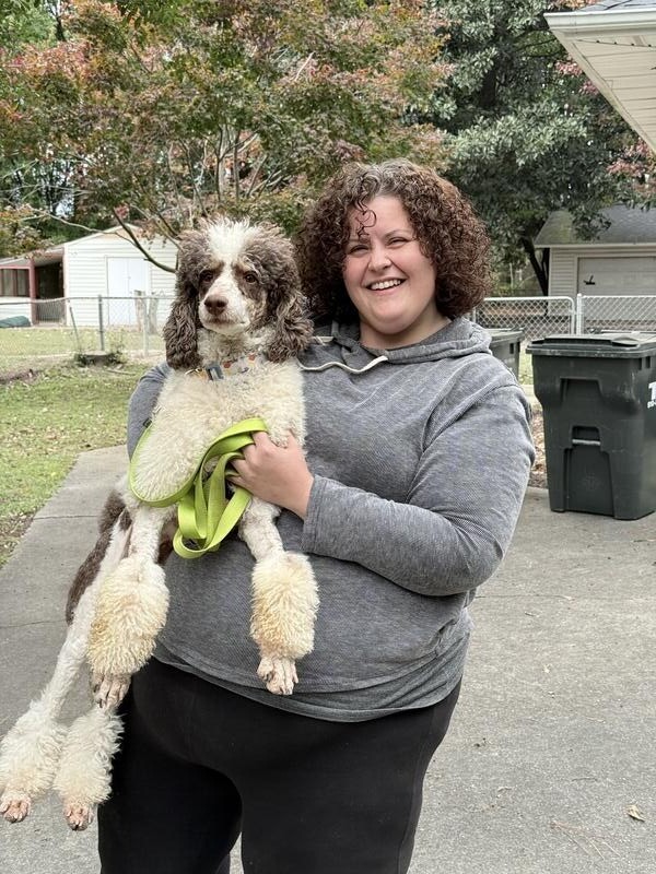 Customer holding their dog after safe delivery by Elite Pet Transportation
