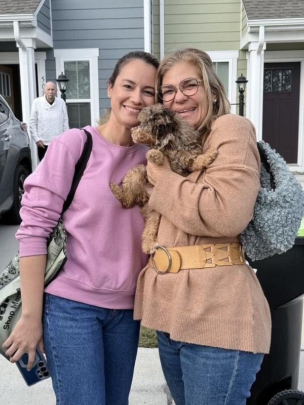 Happy family with their pet after Elite Pet Transportation delivery