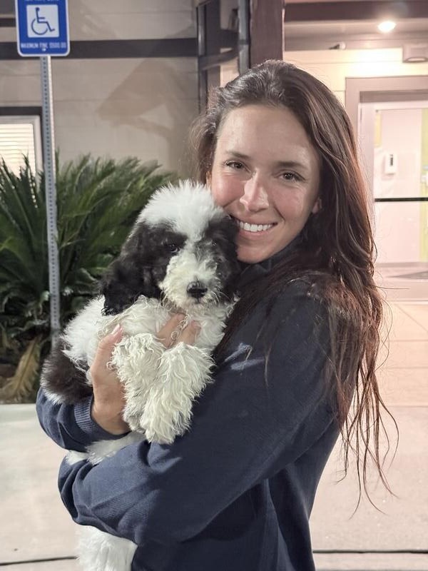 Customer cuddling their puppy after safe pet transport